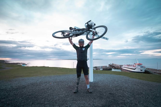 Stuart at the finish line in John o Groats