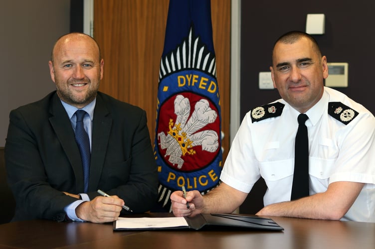 Police and Crime Commissioner Dafydd Llywelyn and Chief Constable Richard Lewis sign the Armed Forces Covenant