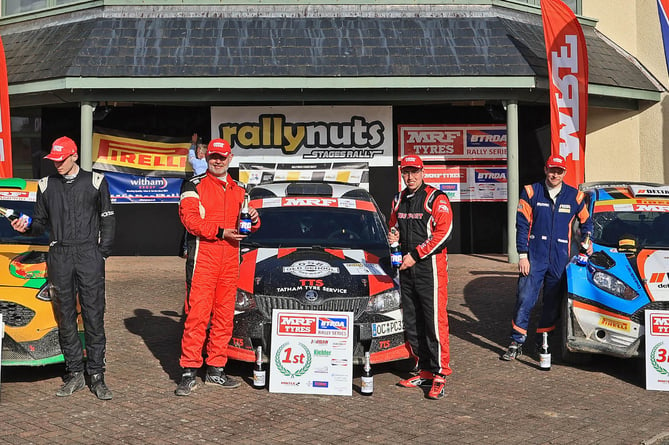 Overall winners (centre) Arron Newby and Jame Edwards with their Škoda Fabia R5