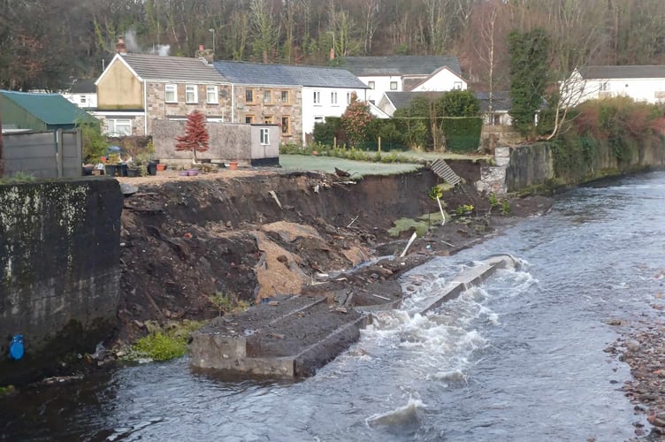 Proportion of resident's gardens disappear into the River Tawe in Ystradgynlais, South Wales, following a landslide. Release date February 2 2024. See SWNS story SWLNgarden. A home-owner was woken by his shocked partner in the middle of the night after she heard a mighty bang and saw a sizeable chunk of their garden had collapsed into the river below. Kevin Davies has lived in Ystradgynlais nearly all his life and claims he's been asking Powys County Council and Natural Resources Wales to do something about the crumbling boundary wall between the end of his garden on Llys Tawel in the town and the fast-flowing River Tawe below for years.