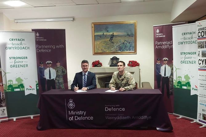 Cllr Matthew Dorrance signing the Armed Forces Covenant on behalf of Powys County Council. Matthew is the Cabinet Member for the Armed Forces Partnership.