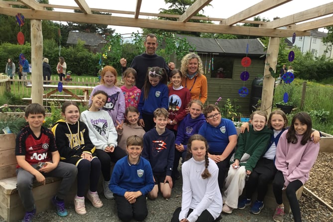 Mrs Gregory with Yr. 5 class and Dr Chris in the school's new allotment.
