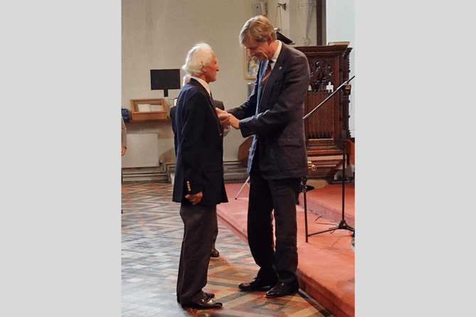 The Lord Lieutenant of Herefordshire presenting RAF veteran John Cary with the Nuclear Test Medal