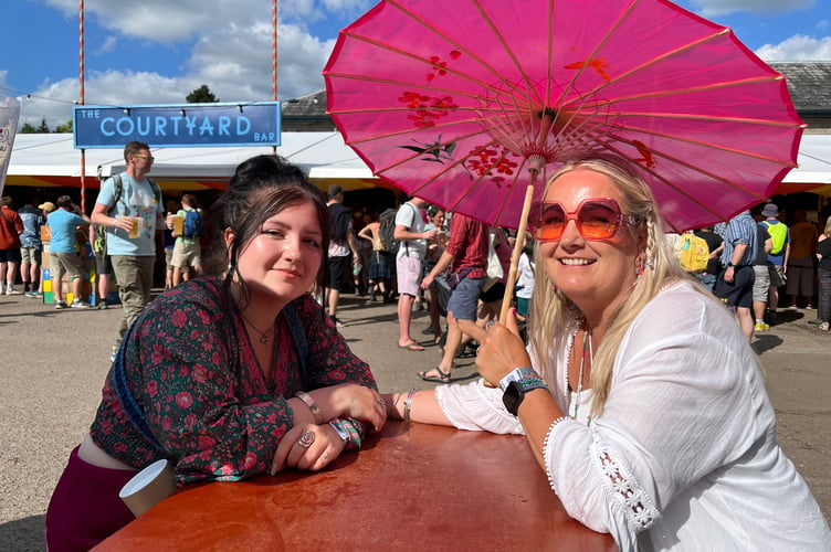 Mother and daughter - Emily (mum with parasol) and Daisy Richards from Salisbury. It was their second time working at the festival