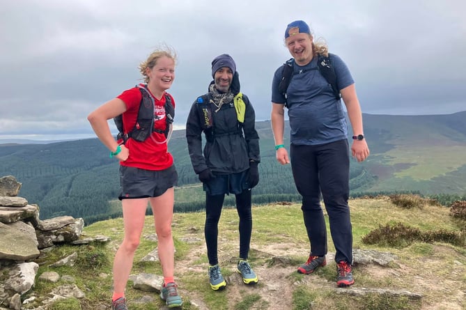 Three runners catch their breath in the Black Mountains Fell Race