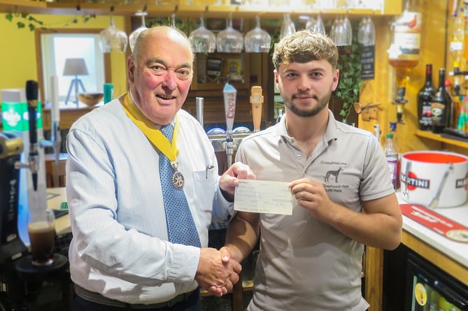 Builth Rotary Vice President, Hugh Garner (left) presenting the cheque to Dan Hilliard