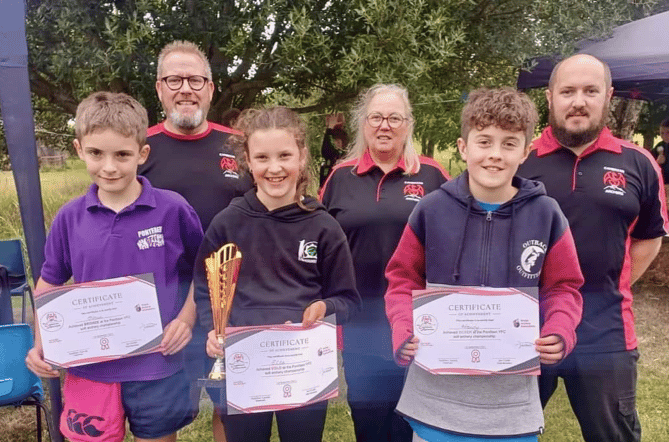 The winners of the archery, new member Ella (centre), Henry second (right of Ella) and Oliver took third place