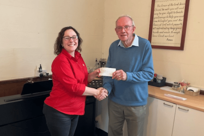 Pentref member Clive Barrett with Samantha Jones from the Salvation Army in Newtown