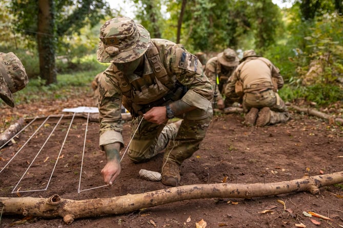 Chilean Army soldiers building their model pit in preparation to deliver their orders before deploying onto EXERCISE CAMBRIAN PATROL 2024.

Soldiers from across the world are readying themselves for the ultimate challenge of military fieldcraft, navigation, tactics, leadership skills and teamwork.
This all takes place across the undulating terrain of Bannau Brycheiniog (Brecon Beacons) where Exercise Cambrian Patrol has had its roots since 1959.

Around 1,000 troops, spread across eight phases of the event, will be faced with a mock mission that includes covering more than 40 miles from east to west, dealing with enemy threats and various other challenges.

Lieutenant Colonel Will Peltor, Officer Commanding this year's event, said: ÒAs we mark the 65th year since the first Exercise Cambrian Patrol took place itÕs important to note that the event maintains its core standards and is as relevant today, in the modern operational environment, as it was for Territorial Soldiers nearly seven decades ago when they were being tested on their Cold War readiness.