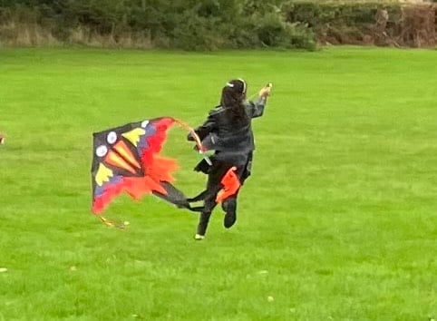 A young girl enjoys flying a kite 