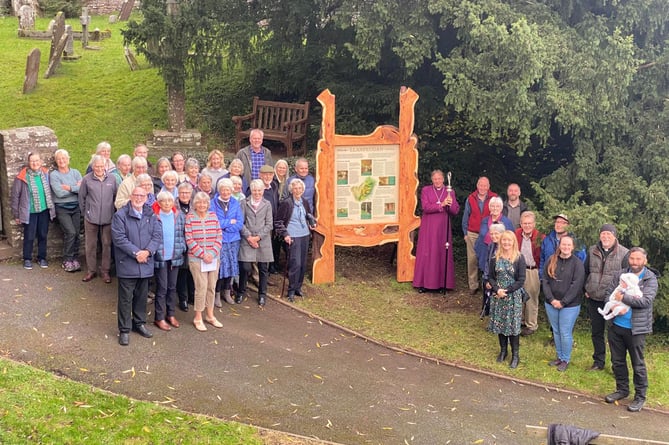 The community with the sign at St Meugan's