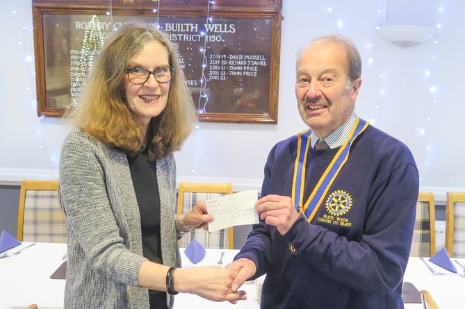 Builth Rotary President Robert Evans presents a £400 cheque to Sally Dwyer, trustee of Builth Wells Community Support