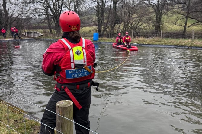 Rescue teams engage in water rescue operations as part of the course