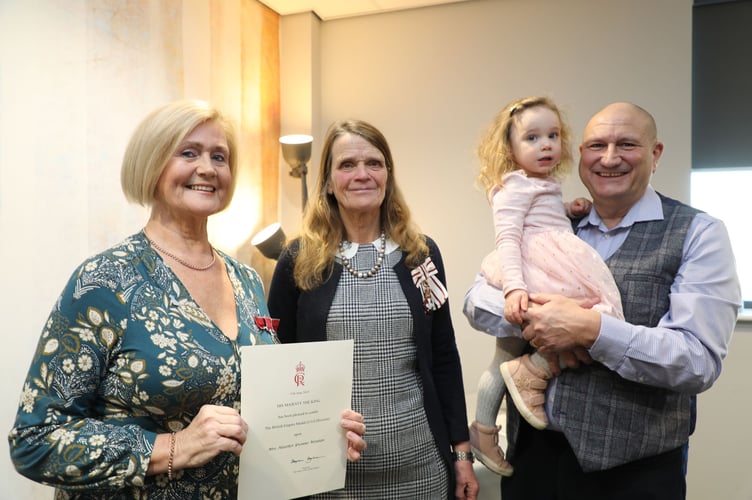 Heather Wenban (left) is pictured at the ceremony at Newtown where she was presented with the British Empire Medal by the Lord Lieutenant Mrs Tia Jones (second from left) and Heather’s husband Paul and grand-daughter Edie