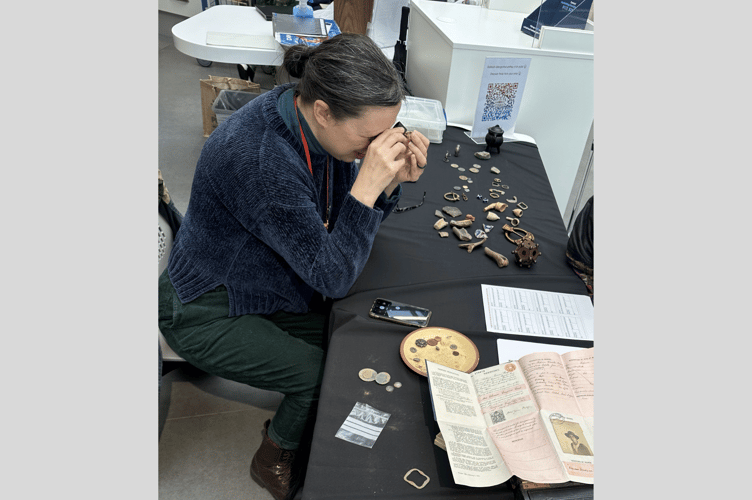 Nicola Kelly from Amgueddfa Cymru - National Museum Wales, examining finds brought in on the day