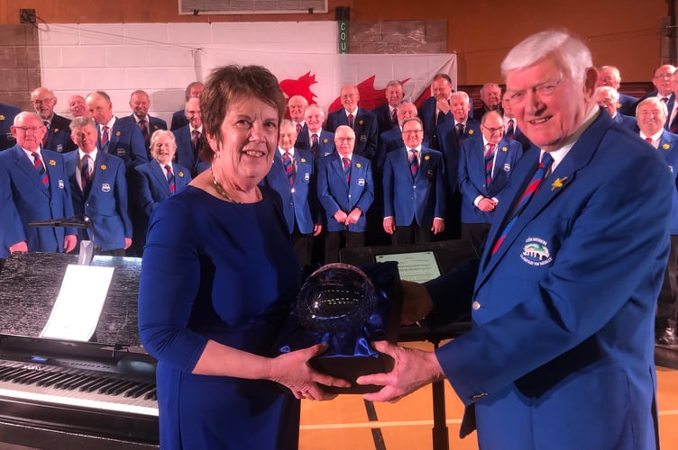 Bob Jones presents Ann Bufton with a cut glass rose bowl in recognition of her 41 years of dedication as accompanist to the choir