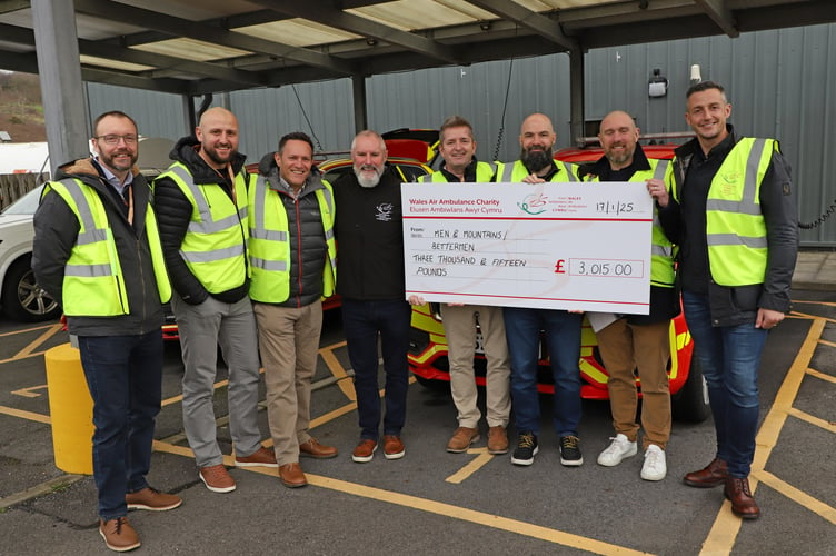 Dan and his Men and Mountains colleagues hand over a cheque to Regional Fundraising Manager, Christian Sullivan