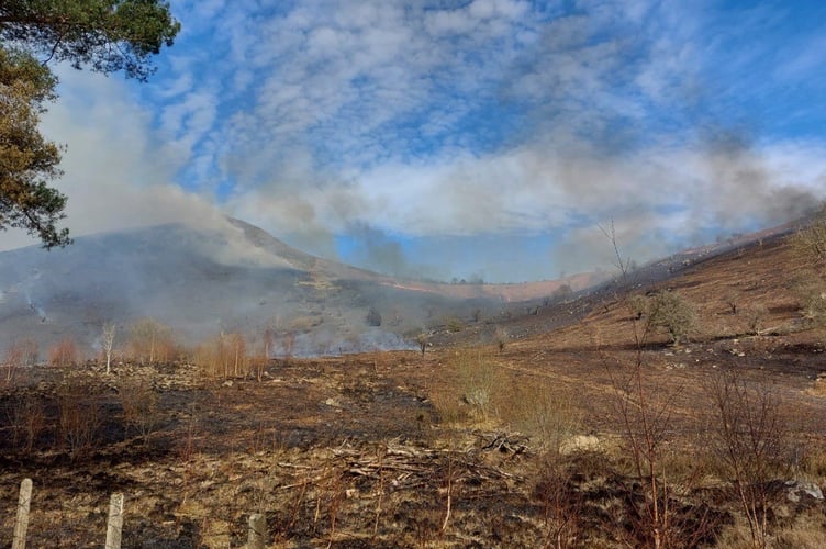 Fire crews are tackling a large grass fire near the A470 in Llanwrthwl